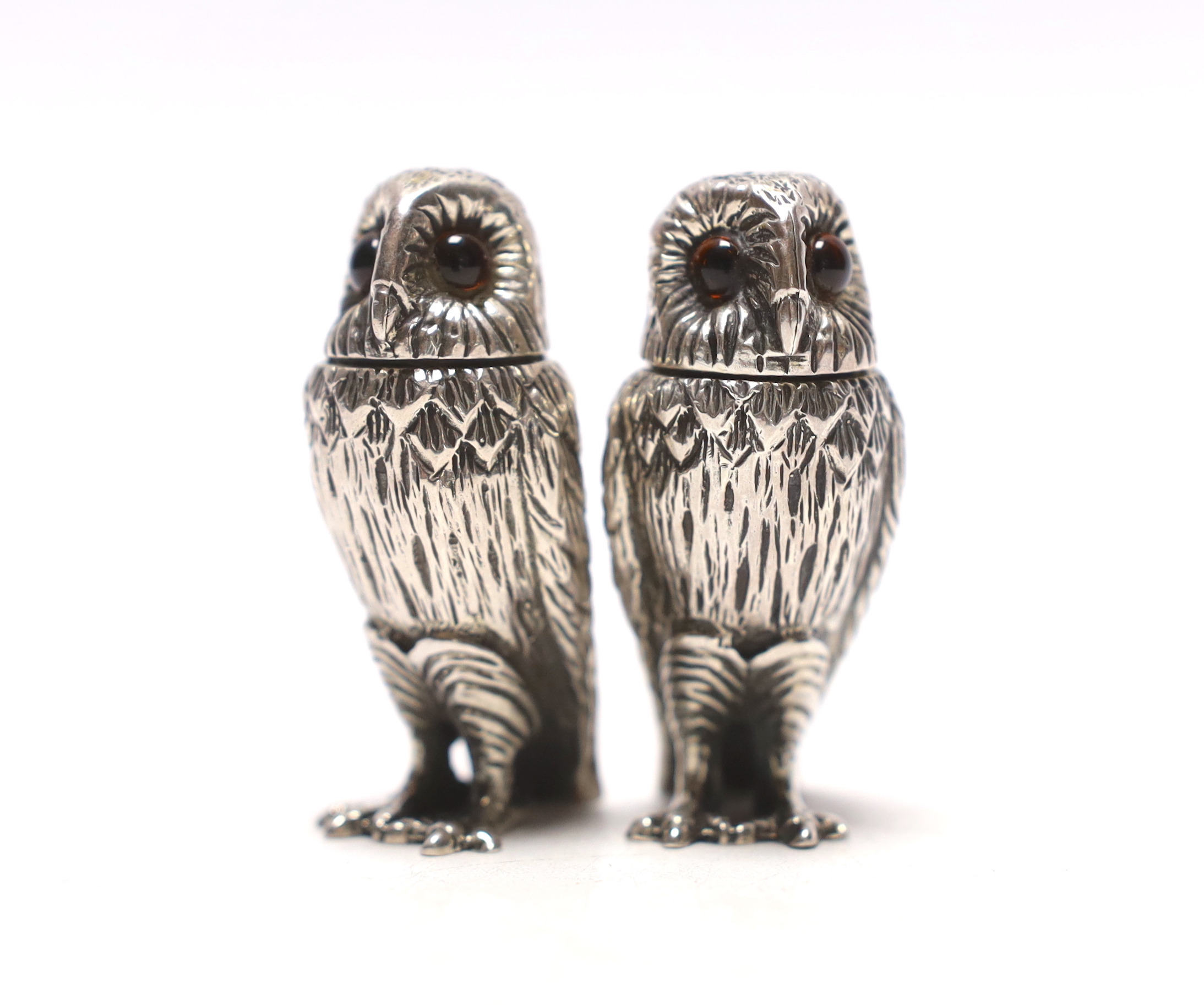 A pair of Elizabeth II novelty silver condiments, each modelled as an owl, maker WW, London, 2008, 51mm.